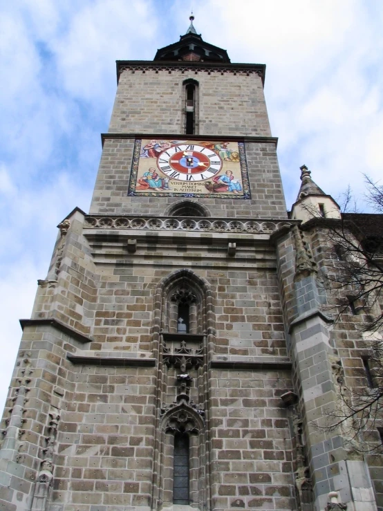 a large stone clock tower in the middle of the day