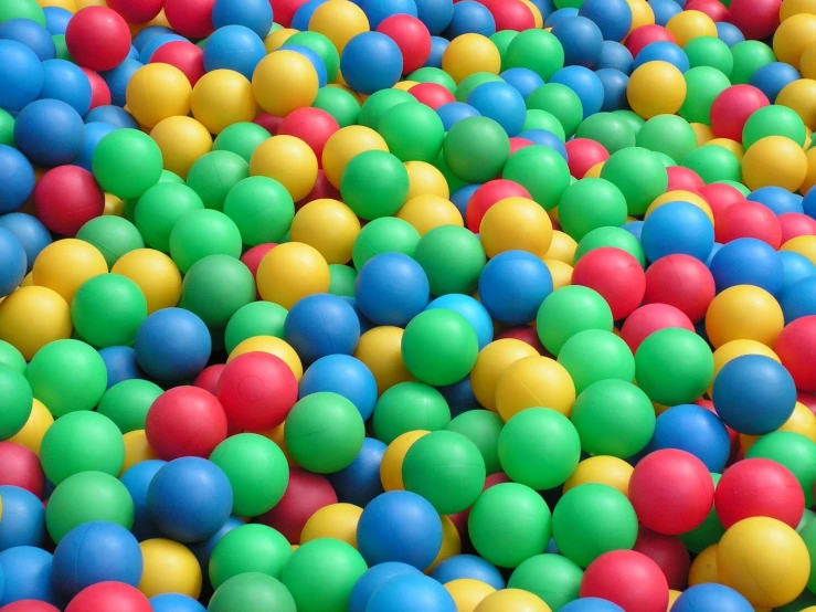 multicolored balls in water in a swimming pool