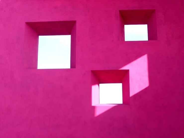 an abstract picture of three square windows on pink background