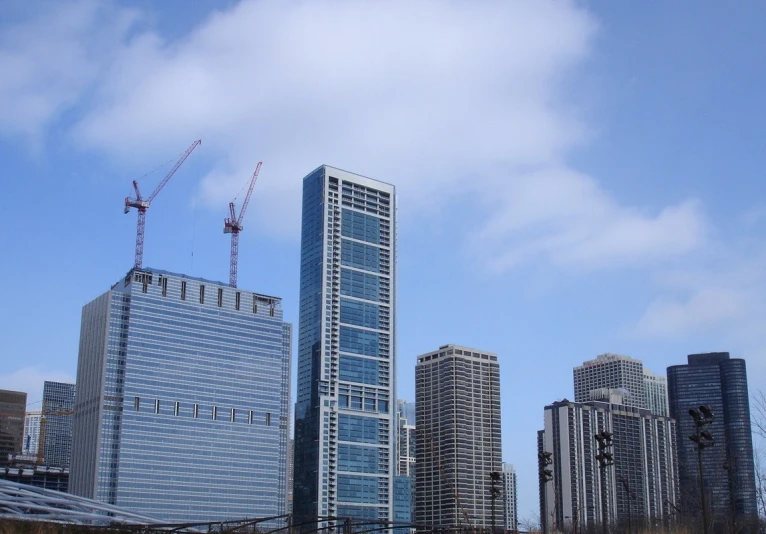 a very tall building standing next to some buildings