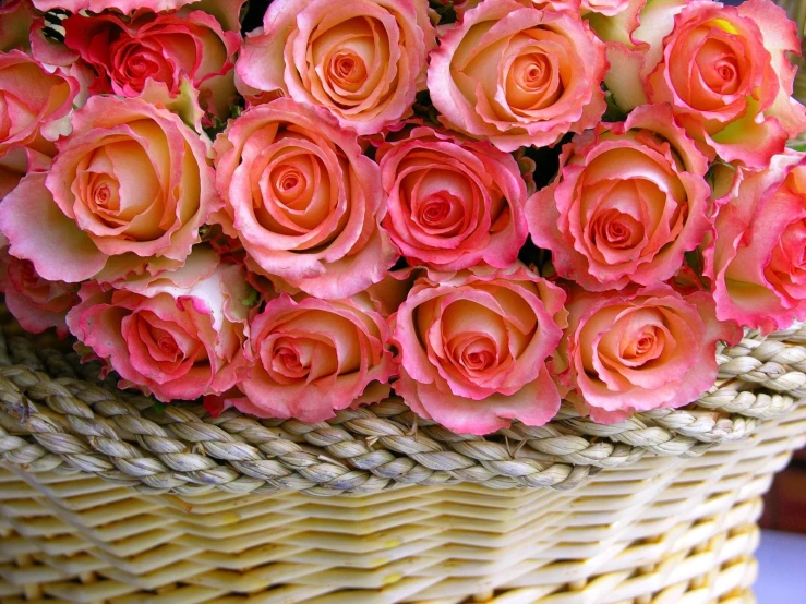 bunches of orange and pink flowers in woven basket