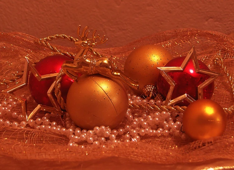 gold and red christmas ornaments with pearls on display