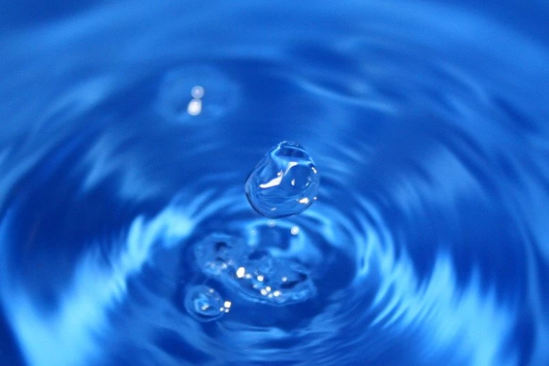 drops of water in a large blue bowl