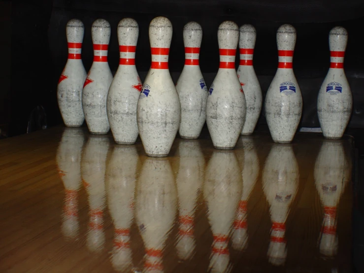 a line up of bowling pins on the floor