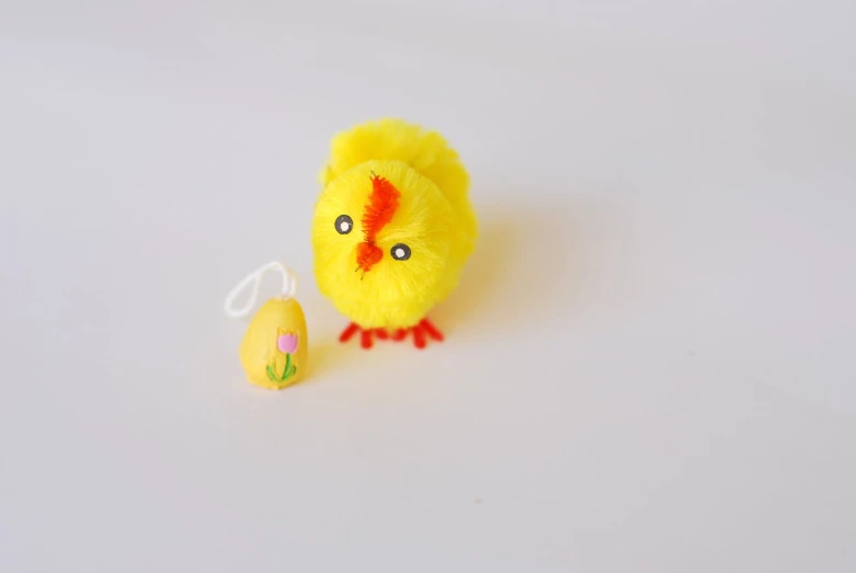 the small stuffed toy is next to a toy chick