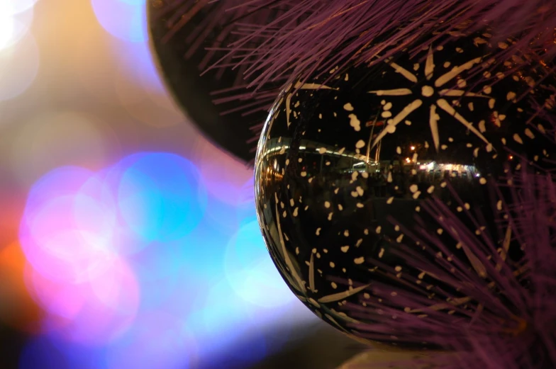 a black, gold and white decorative ball with speckles