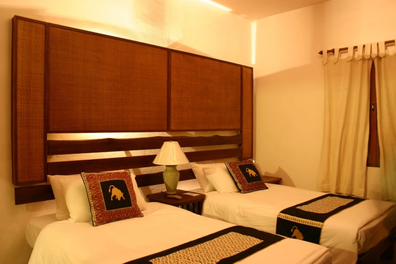 twin beds are displayed in a el room