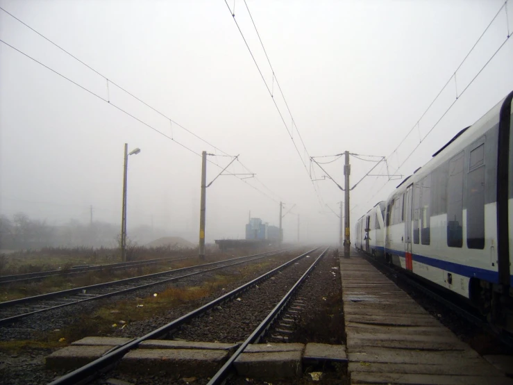 a train on a track in the fog