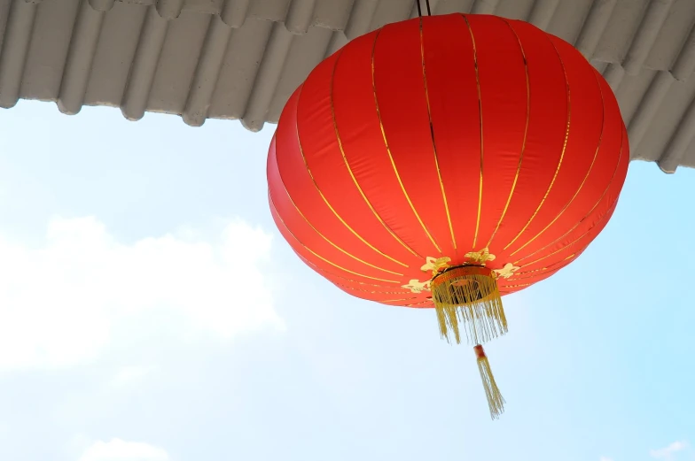 a red chinese lantern hanging in the sky