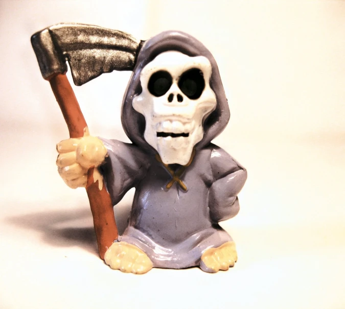 a figurine with a grim skeleton and an axe