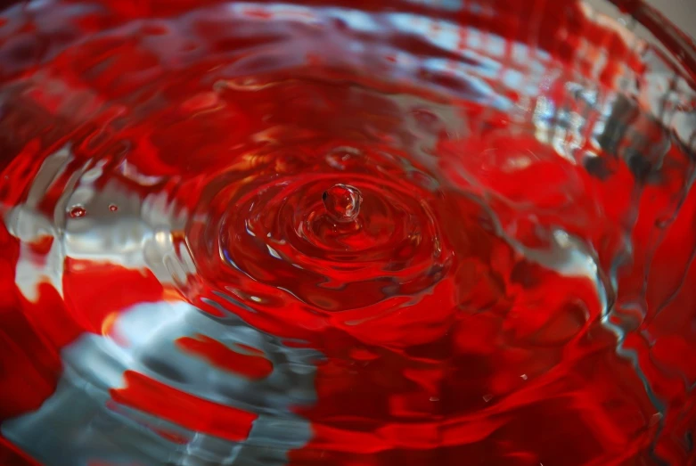 the red glass is reflecting in water