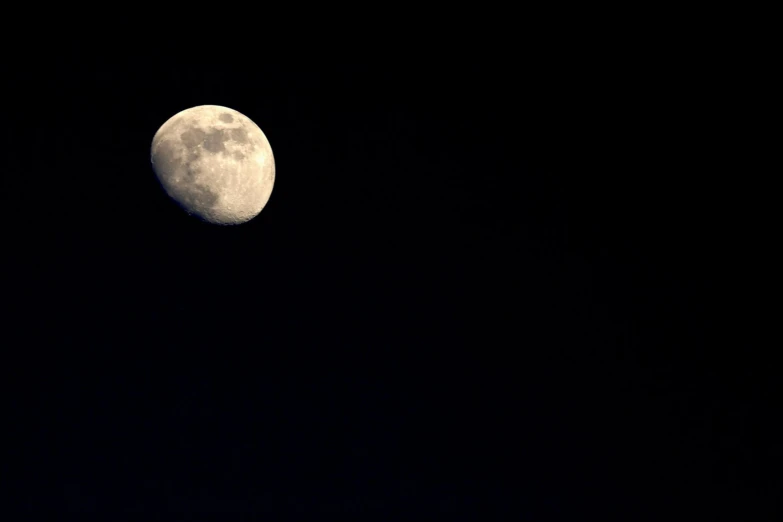 the full moon is shown through a black sky