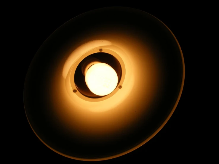 a lit circular object on the black wall