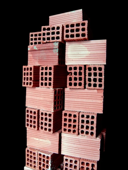 a pile of pink bricks stacked up against one another
