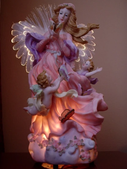 this figurine has a small angel holding a trumpet
