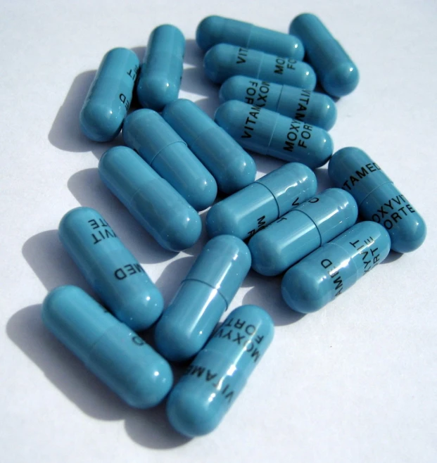 several blue pills sitting on top of each other