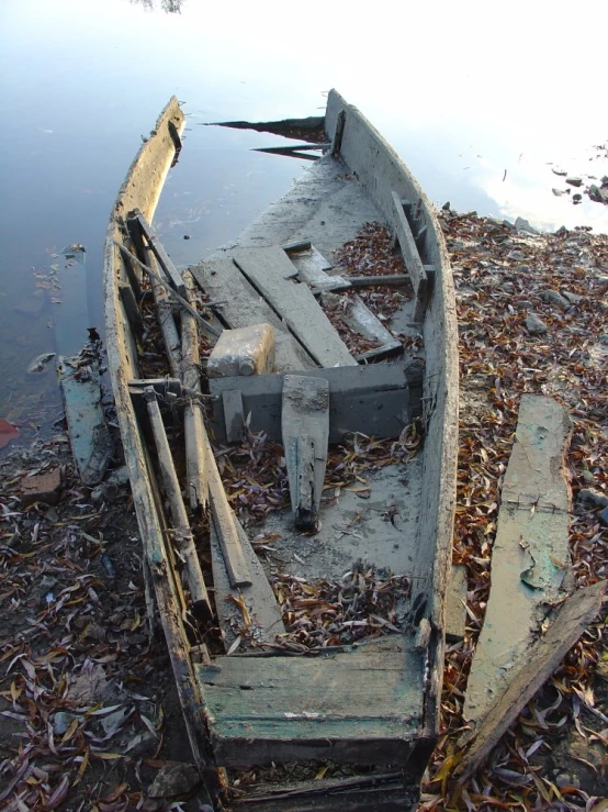 there is an old boat sitting on the dry grass