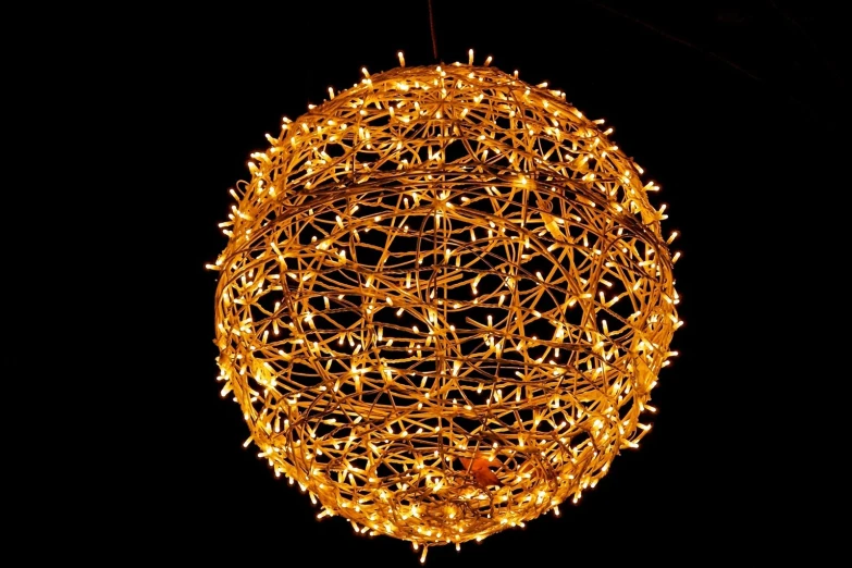 a large orange lighted ball with many strings of lights