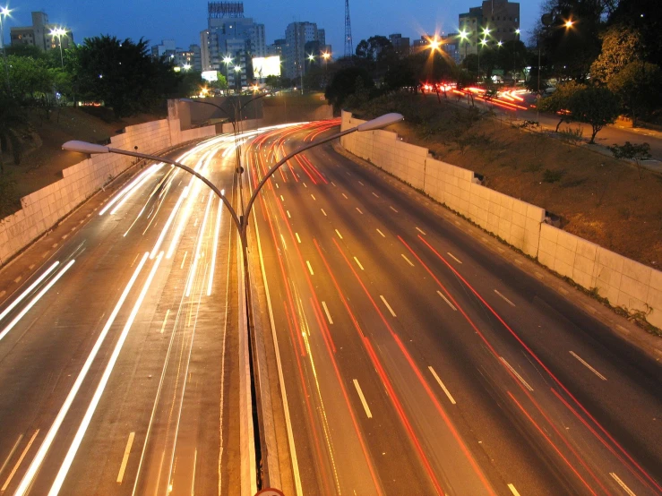 freeway driving in the night near some buildings