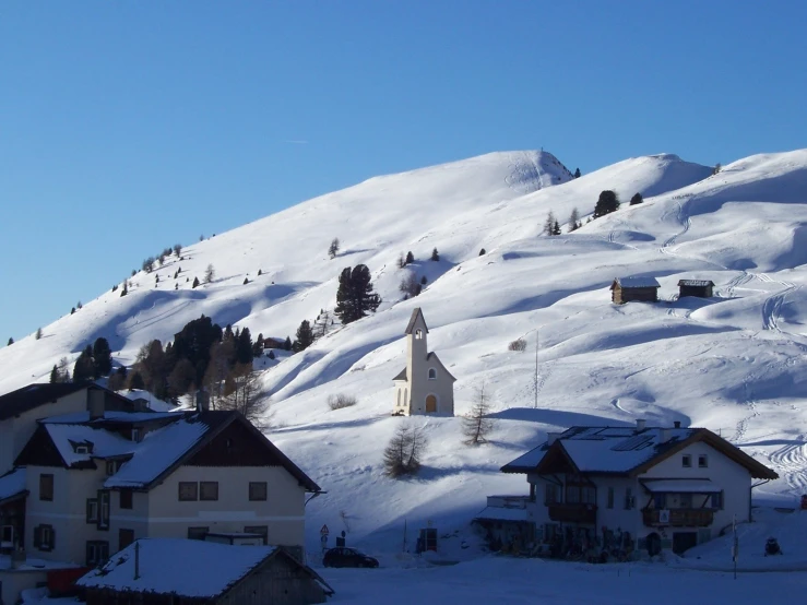 some buildings are shown on the slopes covered in snow