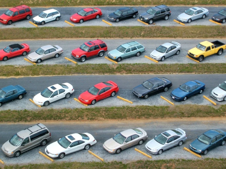 an overhead view of several parked cars in a parking lot