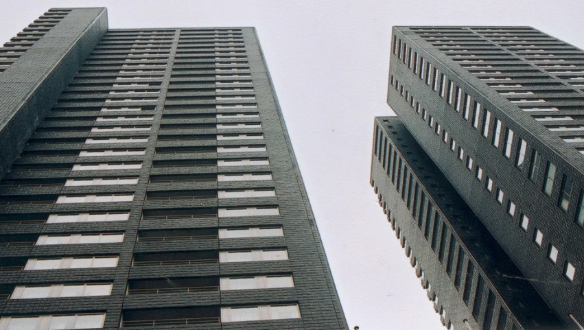 view looking up from the ground at two tall building