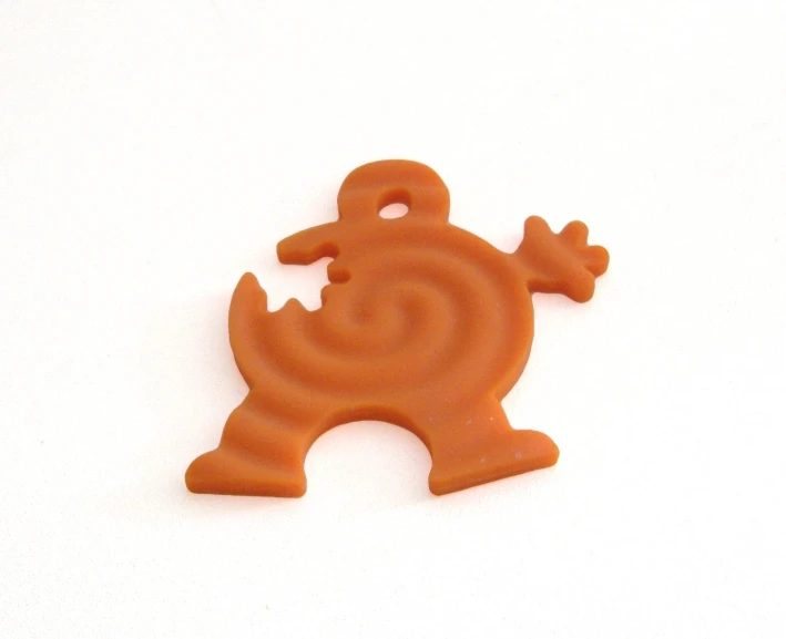 an orange rubber cutout shaped like a character
