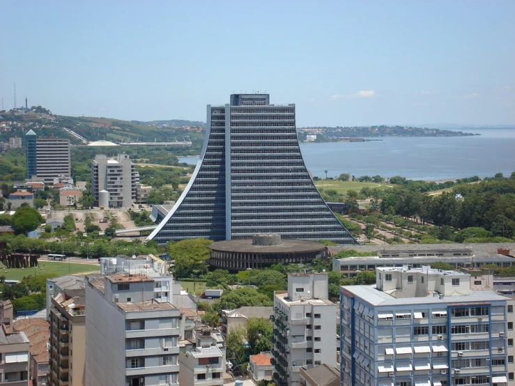 a tall building sits above the other buildings