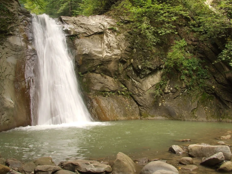 this is a waterfall in the middle of a tropical jungle