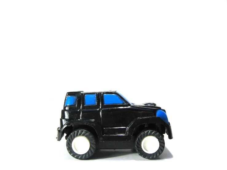 a toy truck with white wheels and black tires