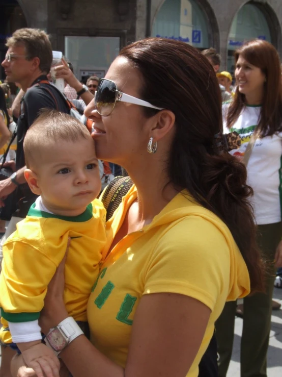 a lady in yellow shirt and sunglasses holding a 