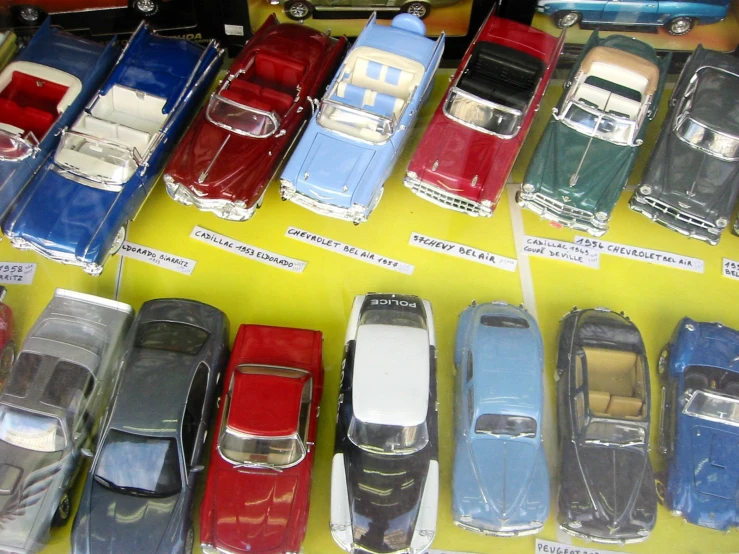 small toy cars are displayed in a display
