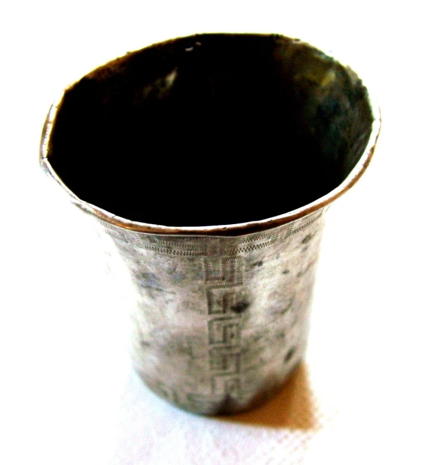an empty, tin cup sitting on a table