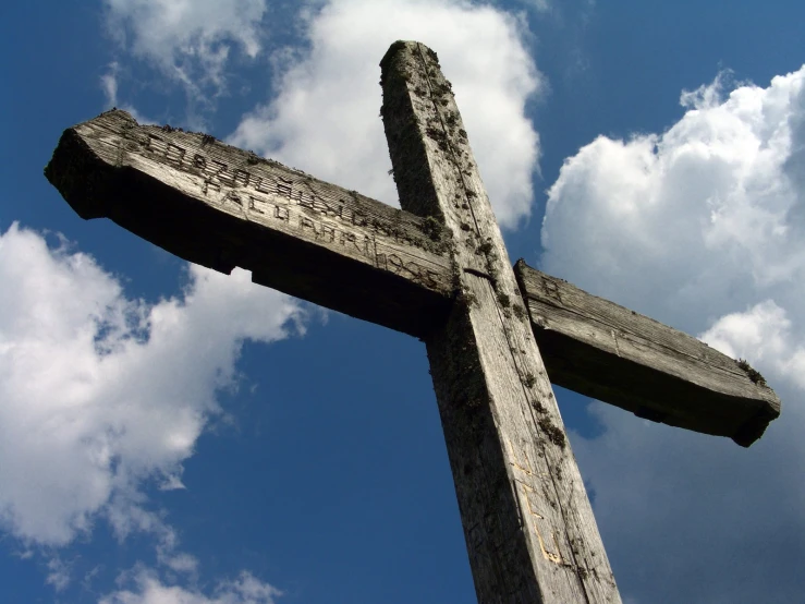 a large wooden cross with writing on it