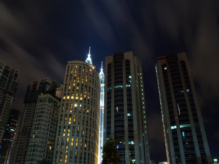 skyscrs with illuminated windows and buildings at night