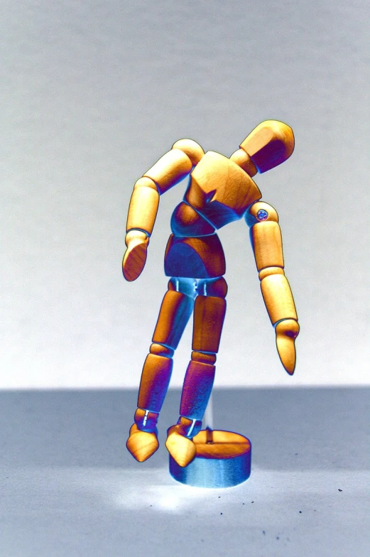 a little plastic figure standing on some kind of object