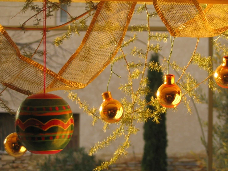 christmas ornaments with decorations around them hanging from a net