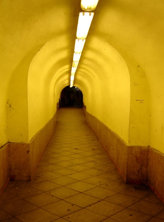 a view from the end of a tunnel with tile on it