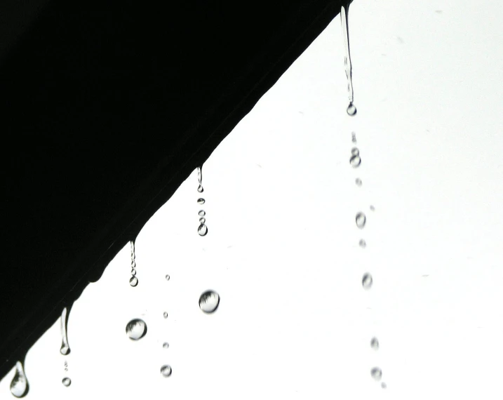 rain drops are falling from the side of a building