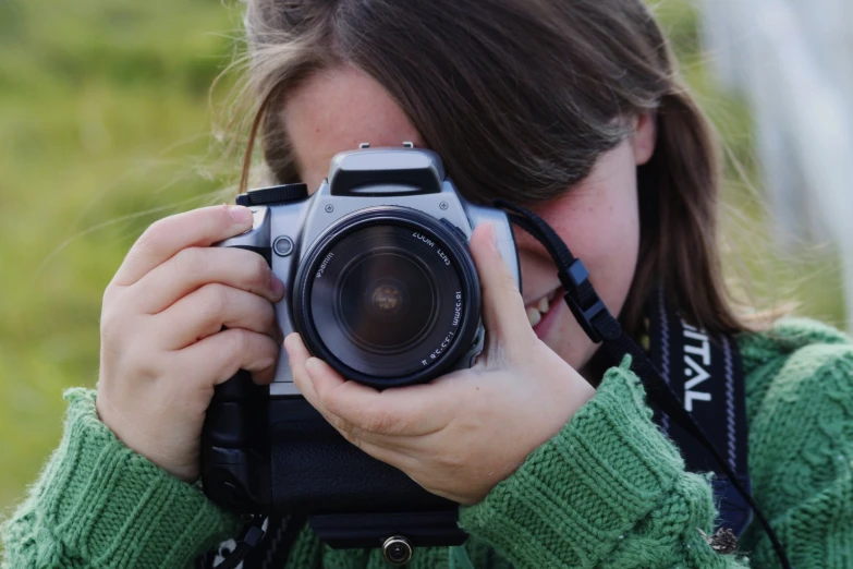 a woman takes a picture with her canon camera