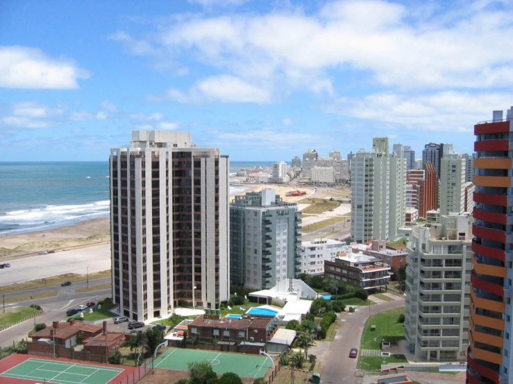 a beach town with buildings overlooking the ocean