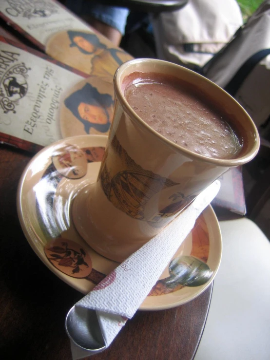 a spoon resting on a cup and saucer