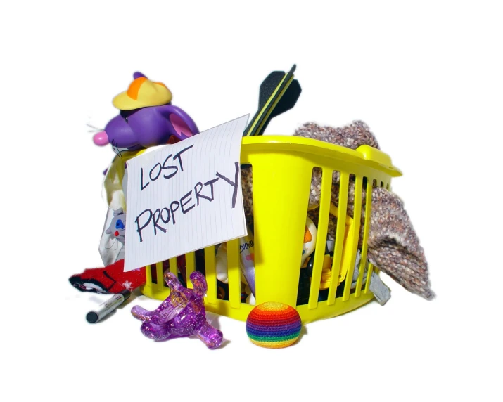 a yellow basket full of toys and stuff sitting on a white floor