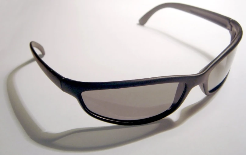 a black sunglasses with a white reflection in the lens