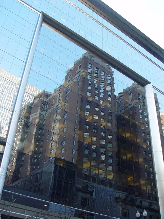 a building reflected in the windows of an office building