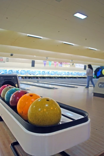 a group of bowling balls sitting in a row on top of a game