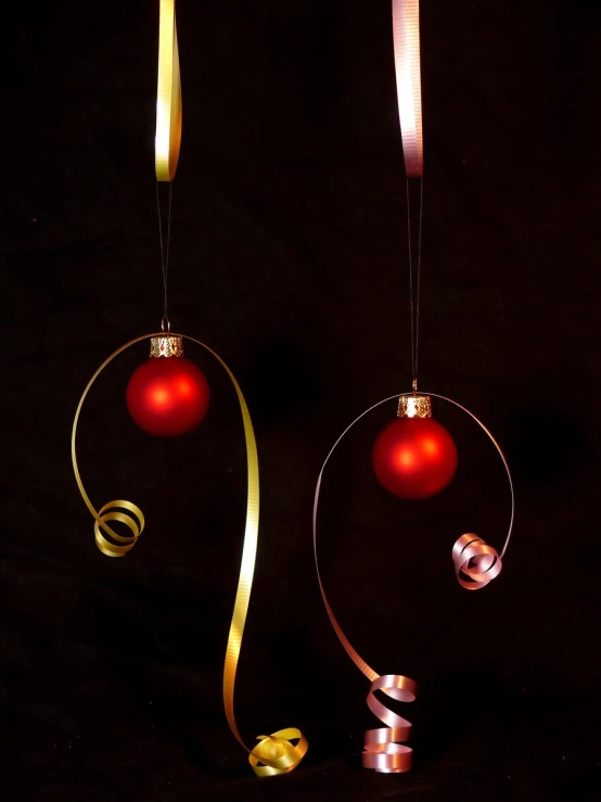 ornaments for a christmas tree, hanging in the dark