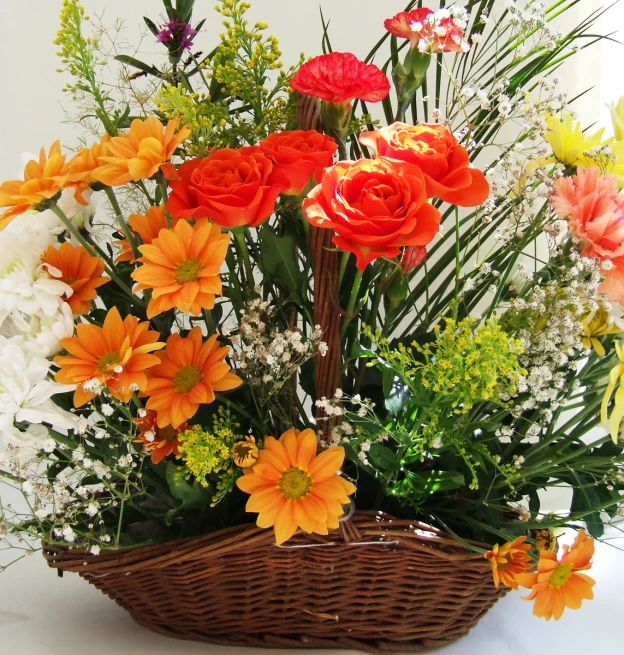 a basket filled with lots of flowers sitting on a table