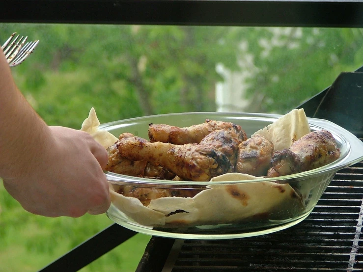 a person is cooking food on the grill