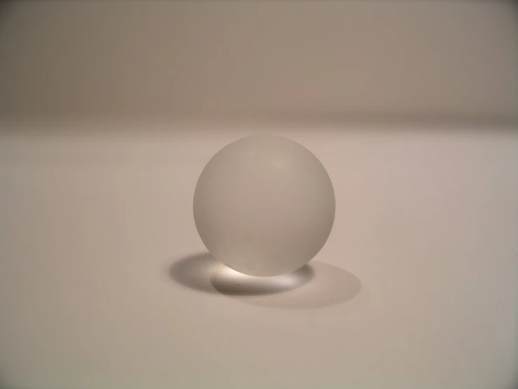 the plastic egg sits atop the table by itself